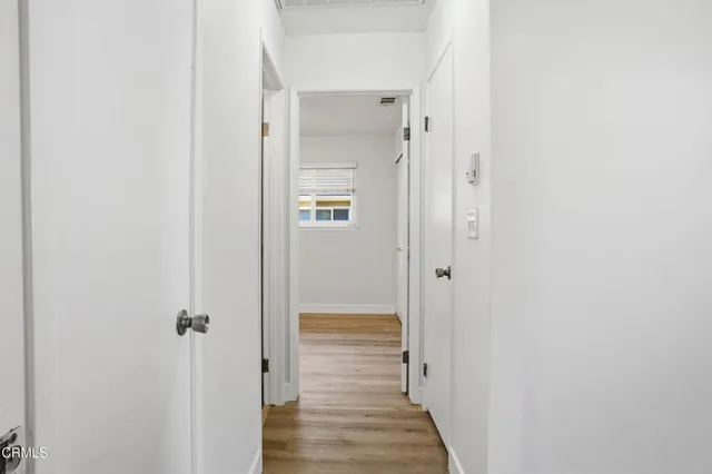 a view of a hallway with wooden floor