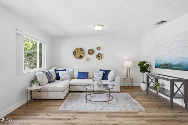 a living room with furniture and wooden floor