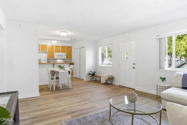 a dining room with furniture and wooden floor