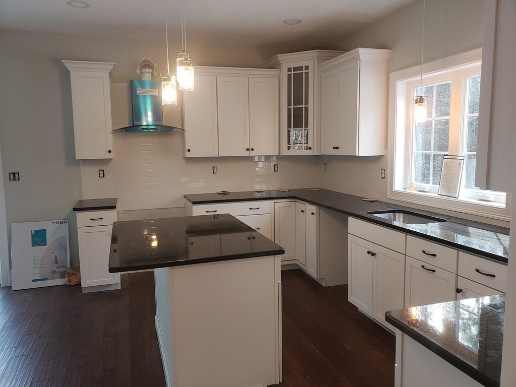 166 Pepperell Road Groton, MA 01450 - Photo 6 of 22 a kitchen with granite countertop a sink a stove and cabinets
