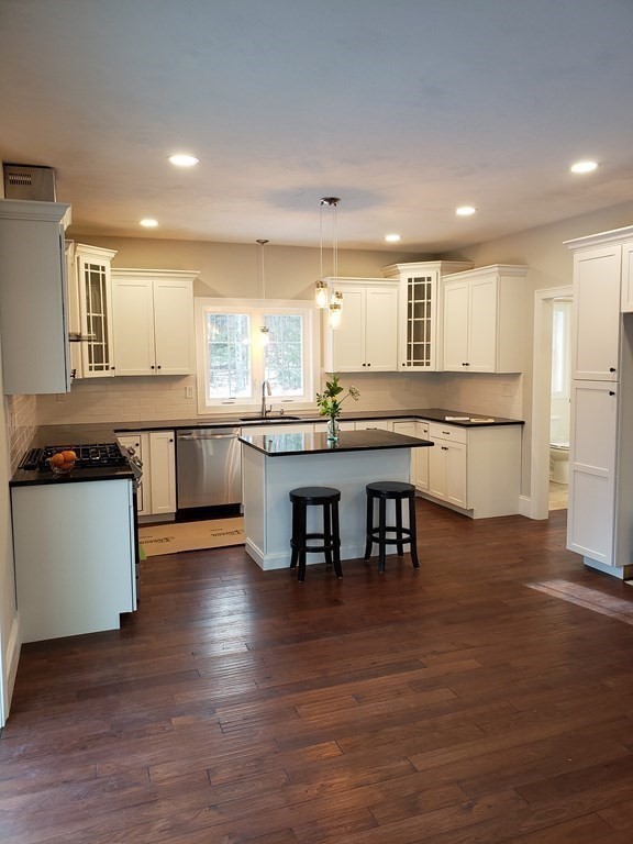 166 Pepperell Road Groton, MA 01450 - Photo 7 of 22 a kitchen with stainless steel appliances granite countertop wooden floor window and cabinets