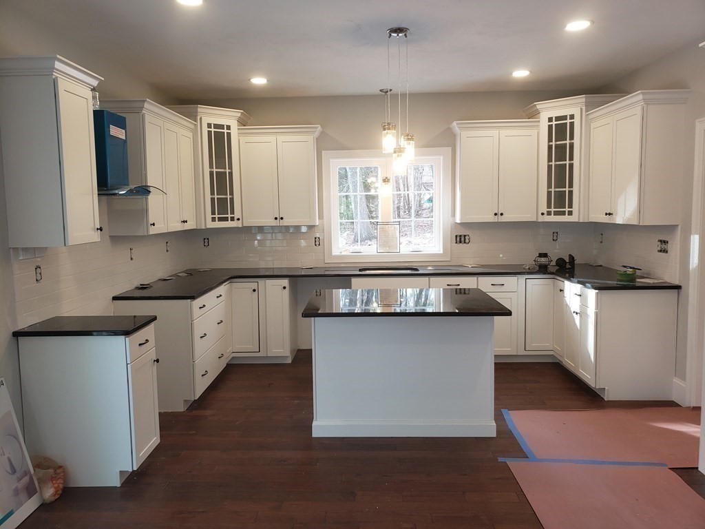 166 Pepperell Road Groton, MA 01450 - Photo 9 of 22 a kitchen with stainless steel appliances granite countertop a sink a stove a refrigerator and white cabinets
