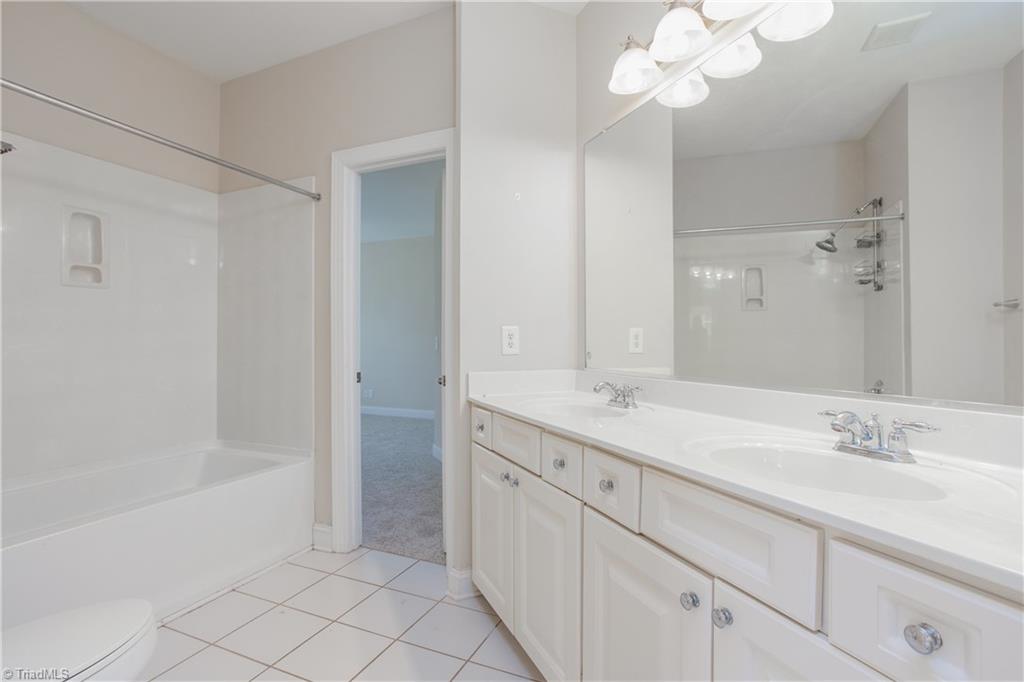 8606 Yvonne Court Oak Ridge, NC 27310 - Photo 19 of 21 Master bathroom with completely separate vanities