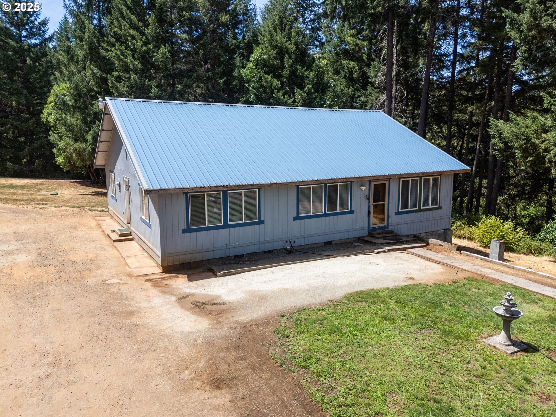 4215 Mt Reuben Road Glendale, OR 97442 - Photo 35 of 40 a house with trees in the background