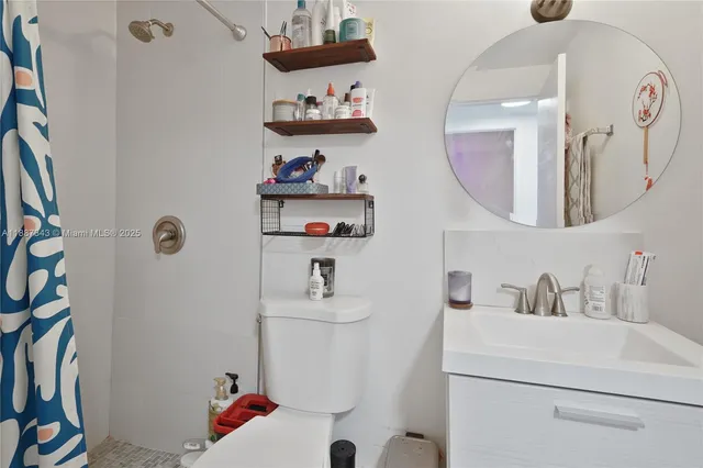 a bathroom with a sink mirror and vanity