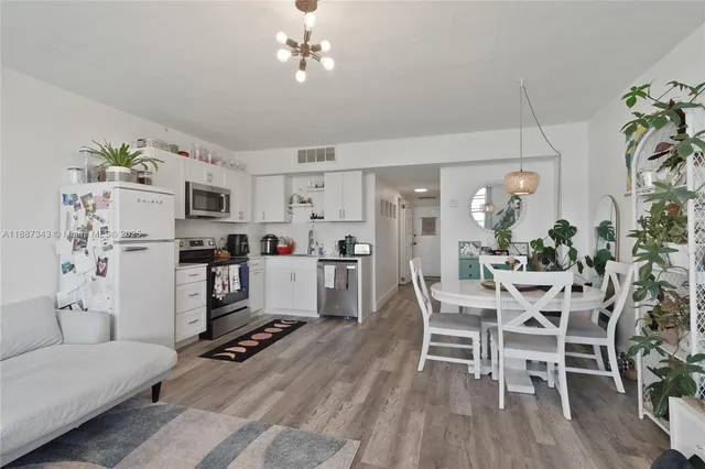 a living room with furniture and kitchen view