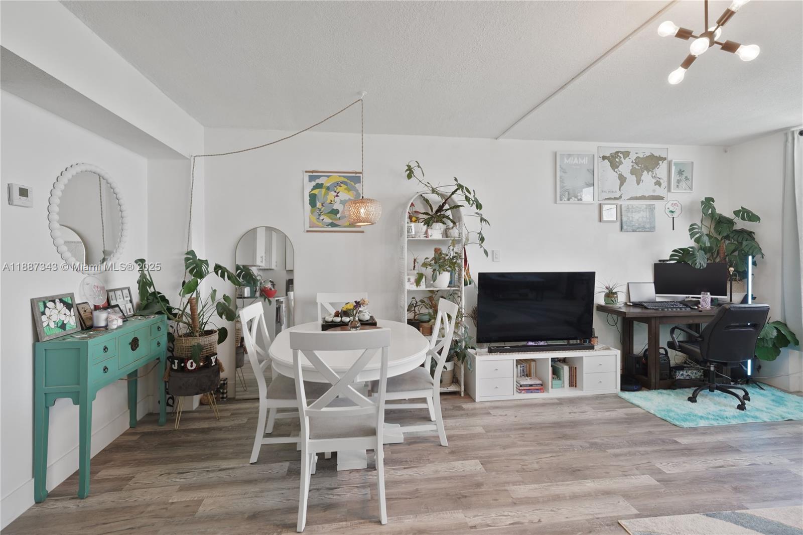 801 Brickell Bay Drive, Unit 1569 Miami, FL 33131 - Photo 3 of 19 a view of a dining room with furniture and wooden floor