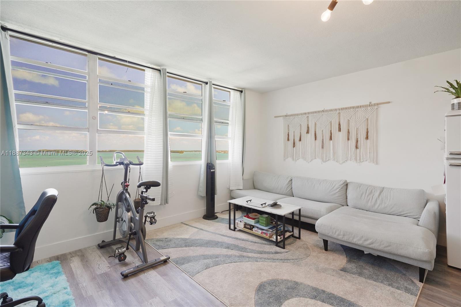 801 Brickell Bay Drive, Unit 1569 Miami, FL 33131 - Photo 5 of 19 a living room with furniture a dining table and a large window