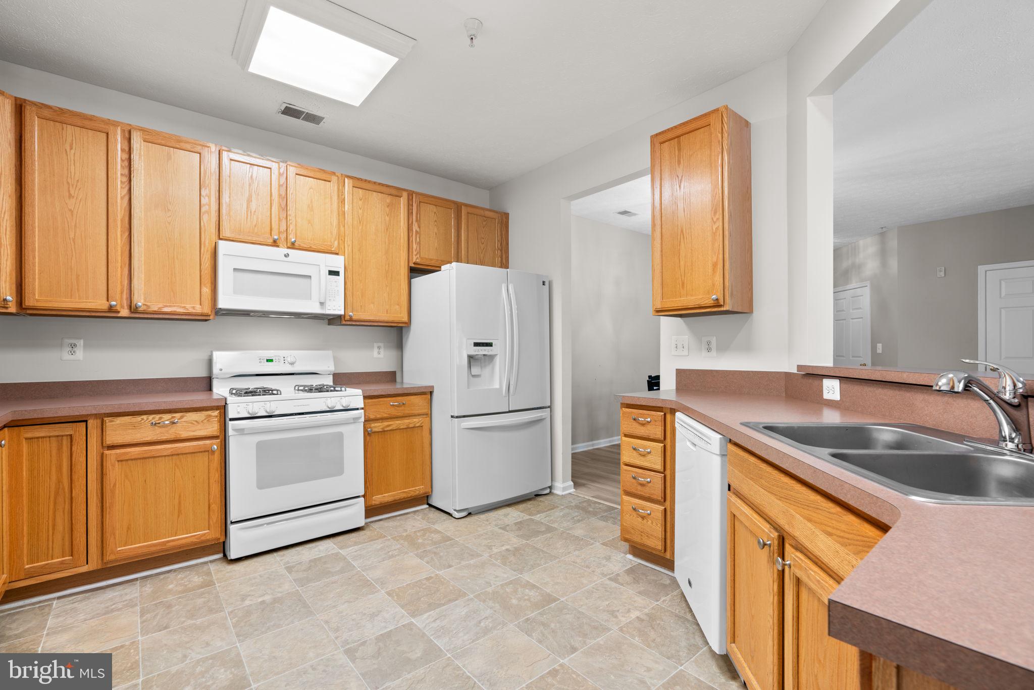 5215 Glenthorne Court, Unit 5215 Rosedale, MD 21237 - Photo 11 of 22 a kitchen with a sink stove and refrigerator