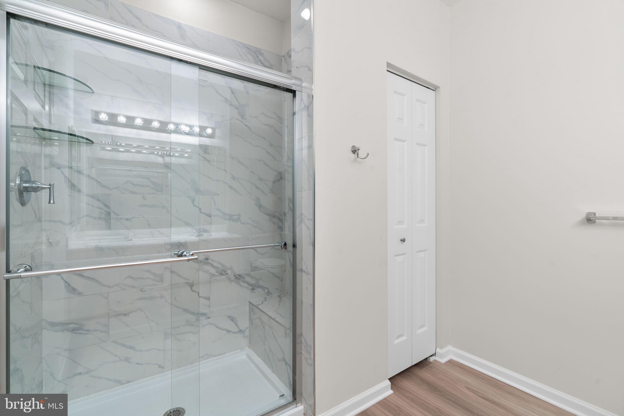 5215 Glenthorne Court, Unit 5215 Rosedale, MD 21237 - Photo 16 of 22 a bathroom with a glass shower door