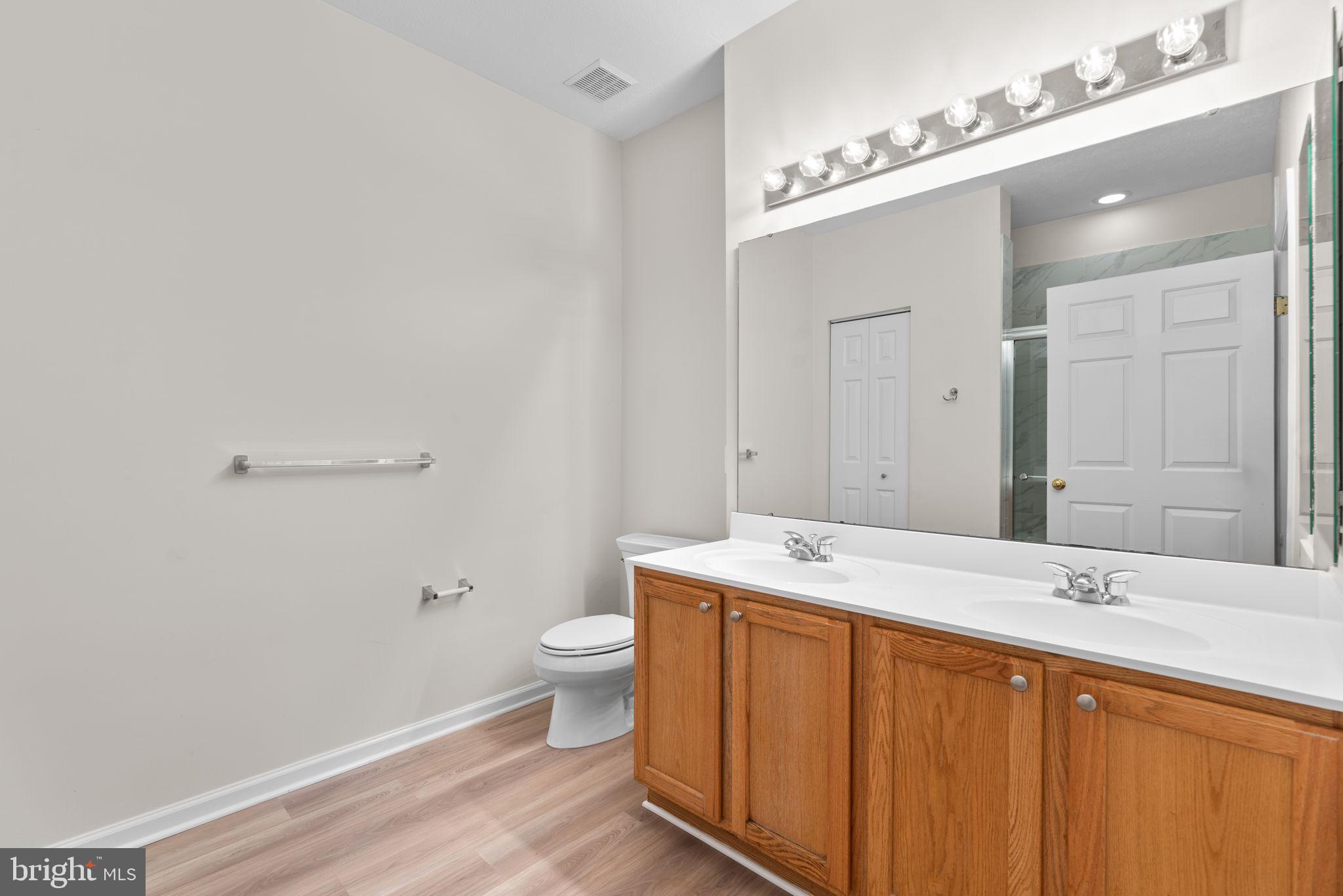 5215 Glenthorne Court, Unit 5215 Rosedale, MD 21237 - Photo 17 of 22 a bathroom with a sink a toilet and mirror
