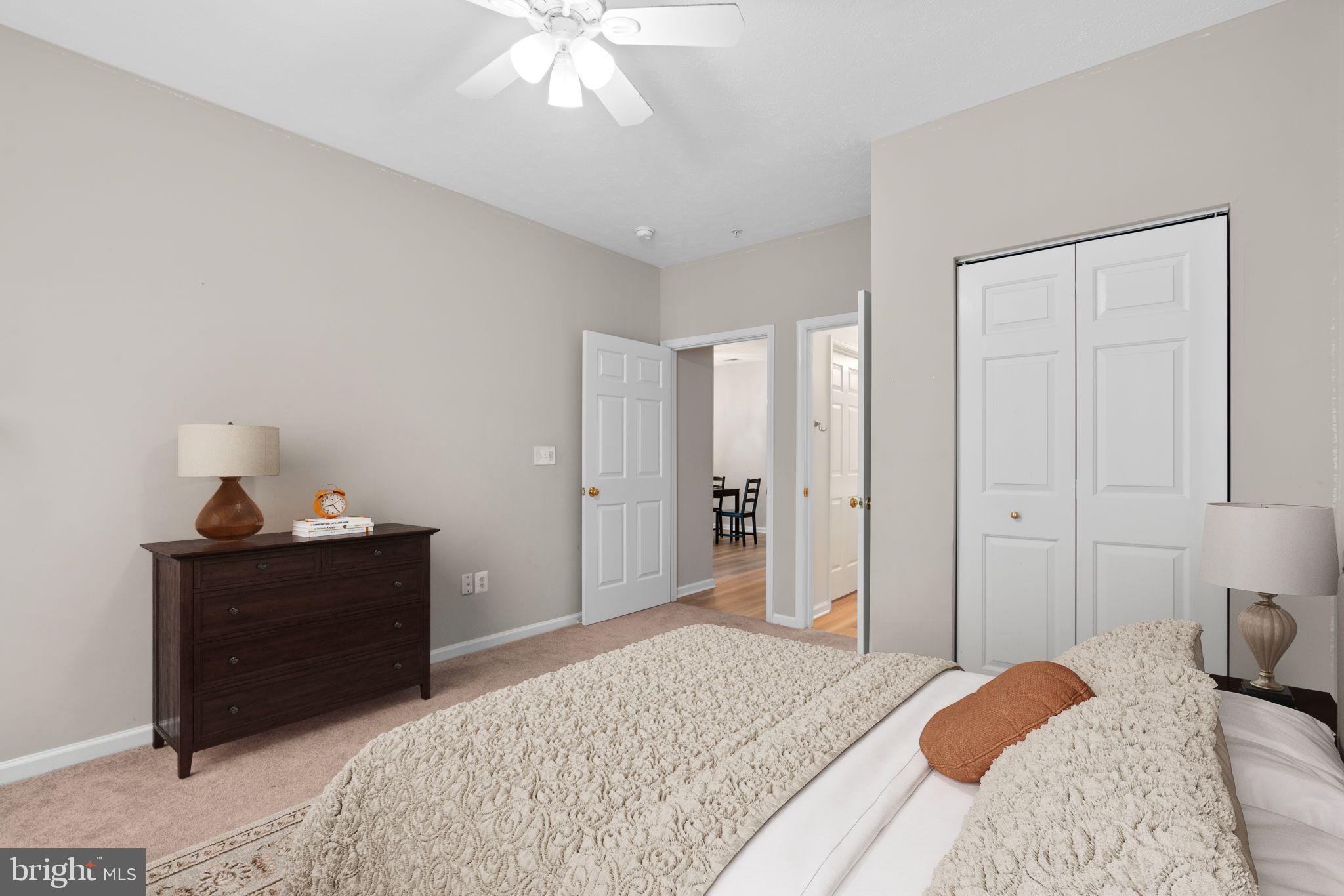 5215 Glenthorne Court, Unit 5215 Rosedale, MD 21237 - Photo 19 of 22 a bedroom with a bed and a chandelier