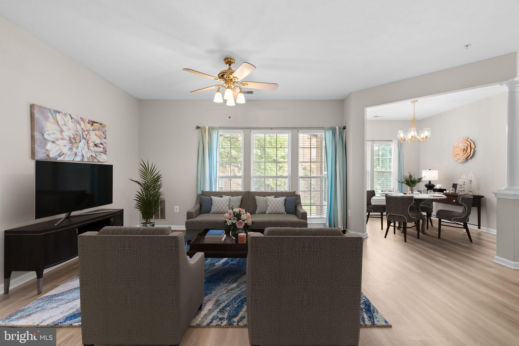 5215 Glenthorne Court, Unit 5215 Rosedale, MD 21237 - Photo 6 of 22 a living room with furniture a flat screen tv and a large window