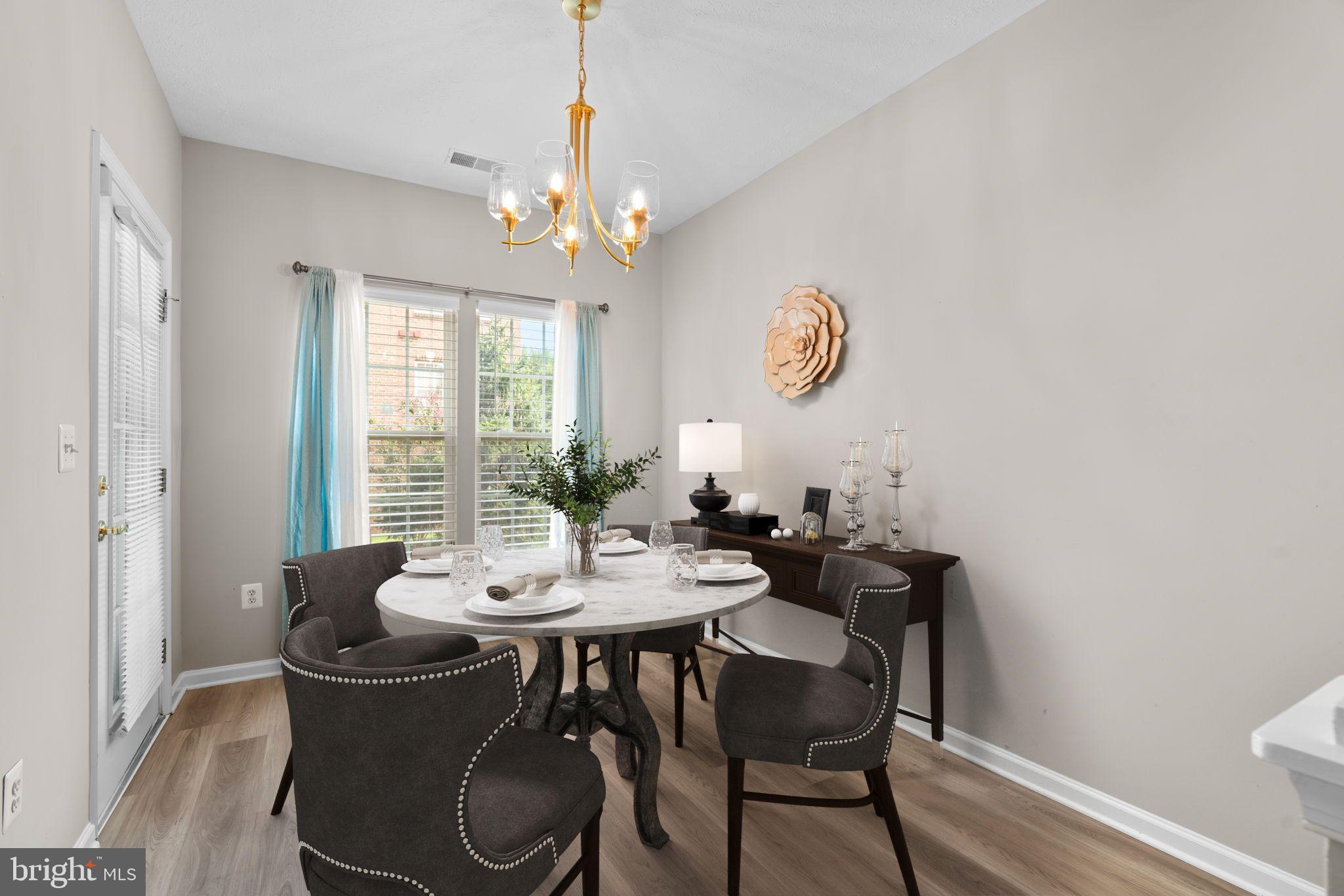 5215 Glenthorne Court, Unit 5215 Rosedale, MD 21237 - Photo 7 of 22 a view of a dining room with furniture wooden floor and chandelier