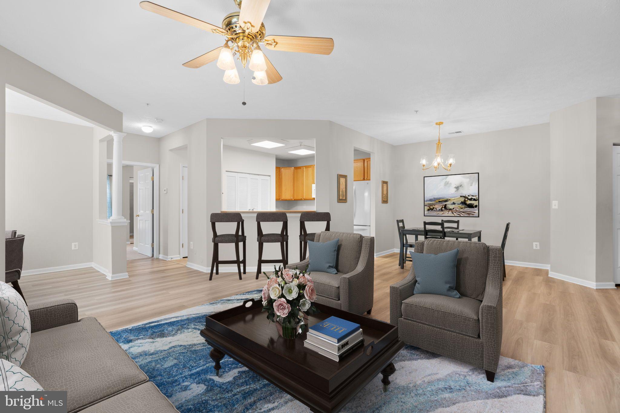 5215 Glenthorne Court, Unit 5215 Rosedale, MD 21237 - Photo 8 of 22 a living room with furniture kitchen view and a chandelier