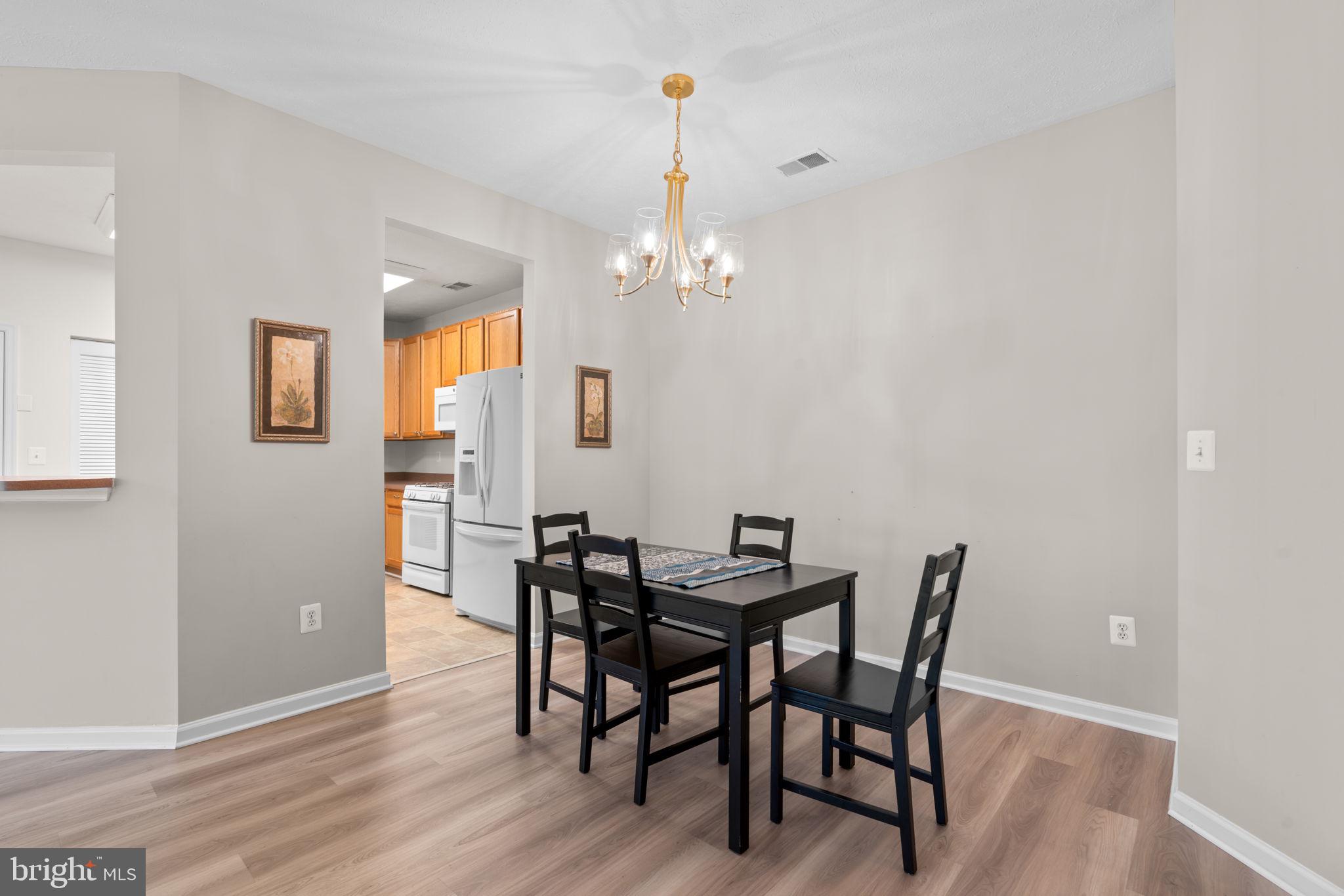 5215 Glenthorne Court, Unit 5215 Rosedale, MD 21237 - Photo 10 of 22 a view of a dining room with furniture and wooden floor