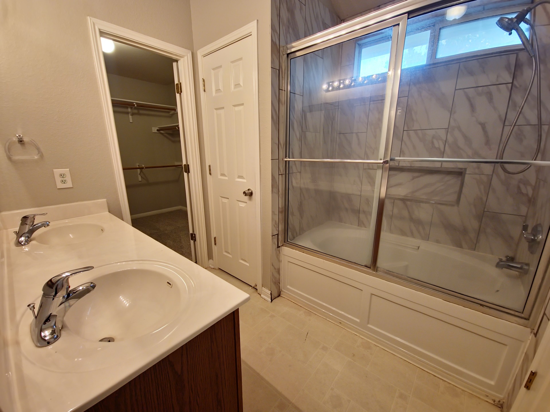 107 Orange Tree Lane Georgetown, TX 78626 - Photo 11 of 16 Double vanity and a tiled shower-tub combo create a functional primary bathroom retreat.