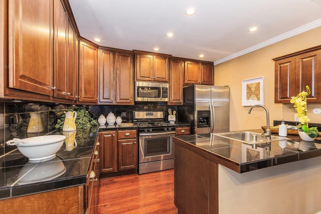 2329 Foothill Road, Unit 1 Pleasanton, CA 94588 - Photo 9 of 15 a kitchen with stainless steel appliances granite countertop a sink a stove and a refrigerator