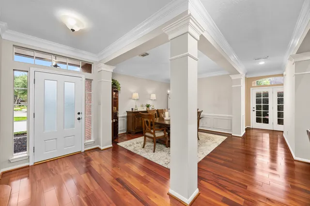 a view of a hardwood floor and windows in a room
