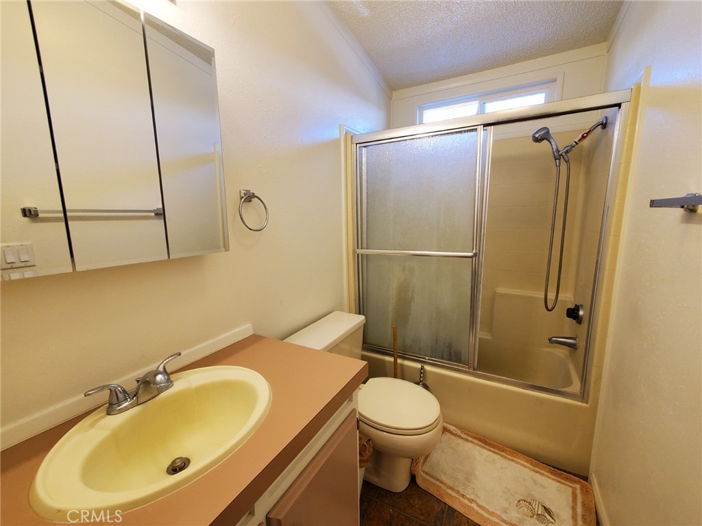 29021 Bouquet Canyon Road, Unit 213 Saugus, CA 91350 - Photo 11 of 17 a bathroom with a sink toilet and shower