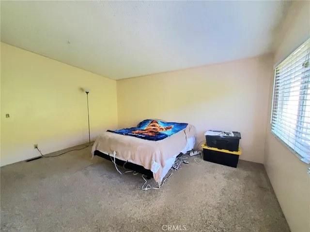 a bed sitting in a room next to a window