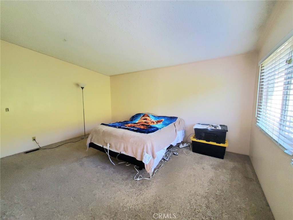 29021 Bouquet Canyon Road, Unit 213 Saugus, CA 91350 - Photo 14 of 17 a bed sitting in a room next to a window