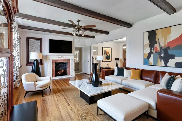 a living room with furniture a fireplace and a flat screen tv