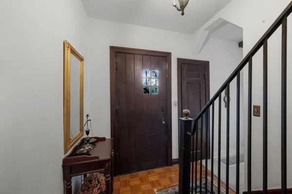 a view of a hallway with wooden floor and stairs