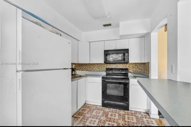 a kitchen with a stove and a refrigerator