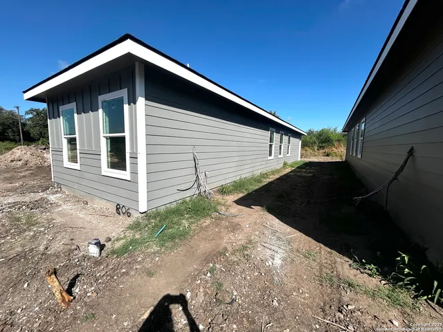 a backyard of a house with large trees