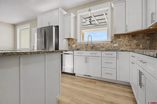 a kitchen with appliances cabinets and a sink