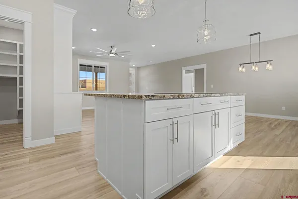 a kitchen with a sink window and cabinets