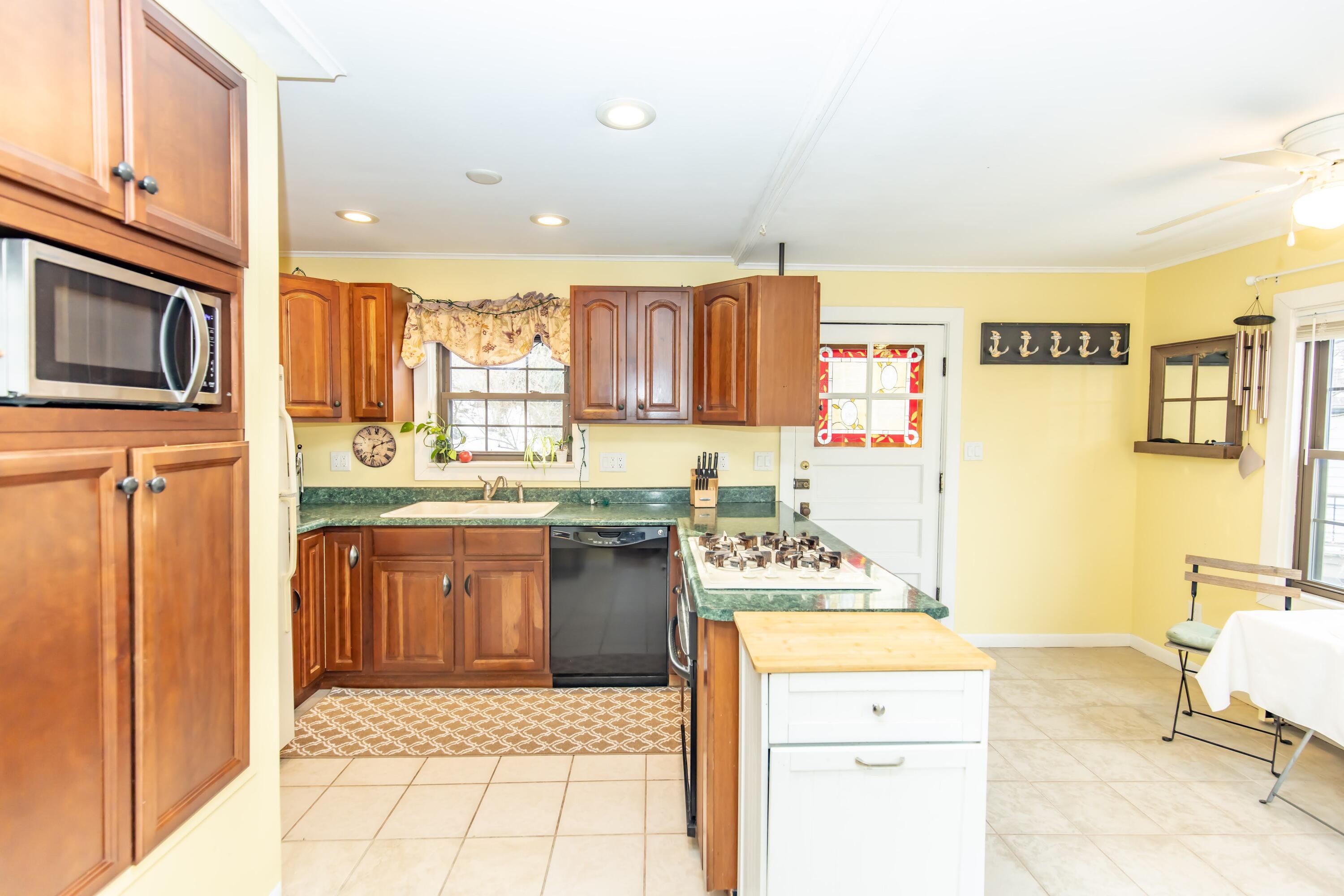 30 Sunset Trail Portage, IN 46368 - Photo 17 of 47 a kitchen with stainless steel appliances granite countertop a stove a sink and a microwave