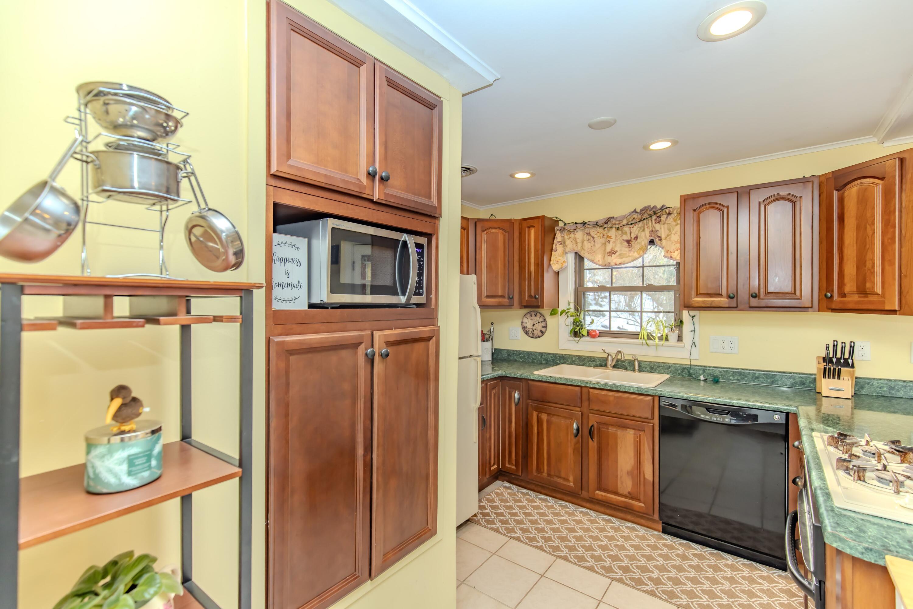 30 Sunset Trail Portage, IN 46368 - Photo 18 of 47 a kitchen with stainless steel appliances granite countertop a sink and cabinets