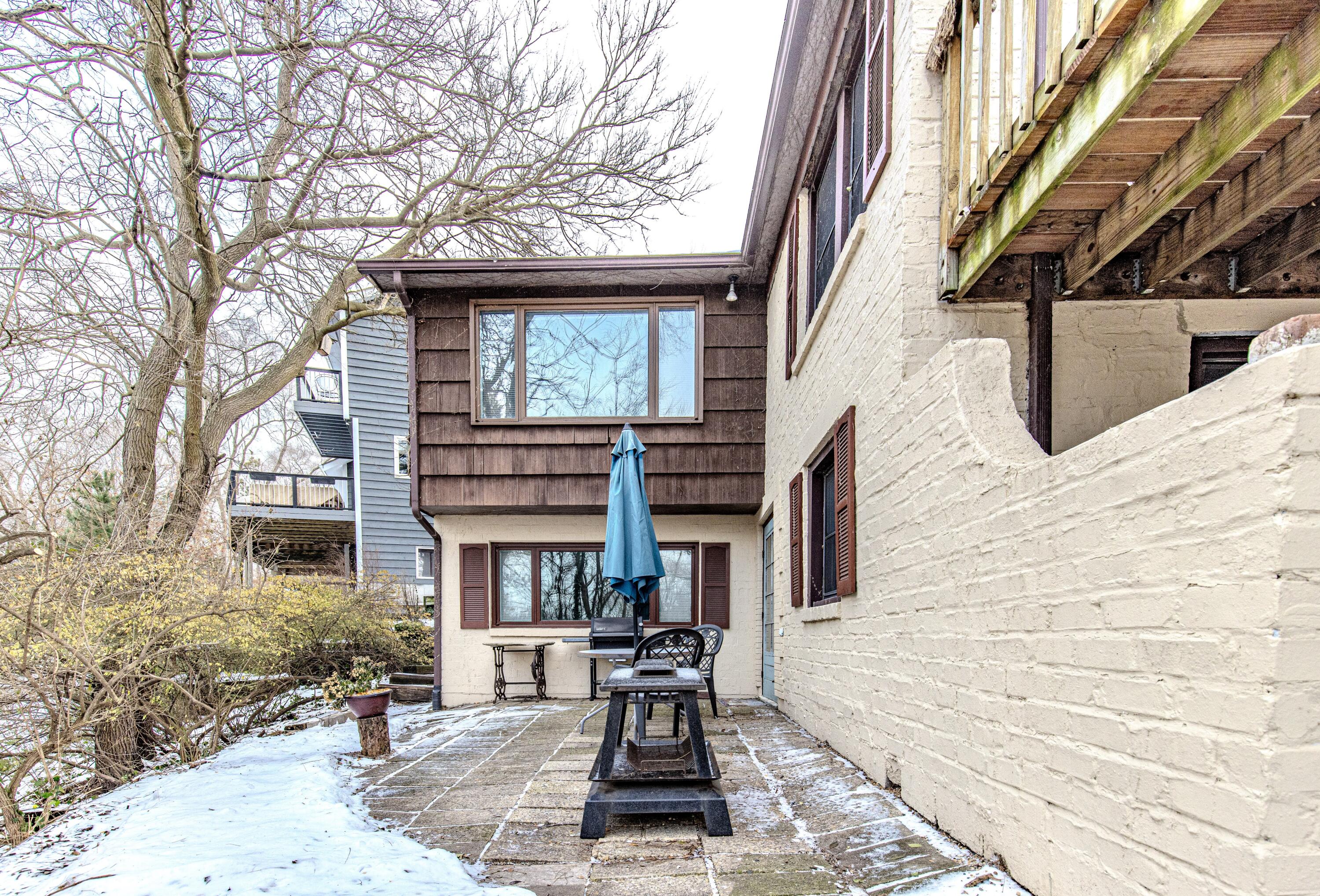 30 Sunset Trail Portage, IN 46368 - Photo 47 of 47 a view of a brick house with a chairs and table in a patio