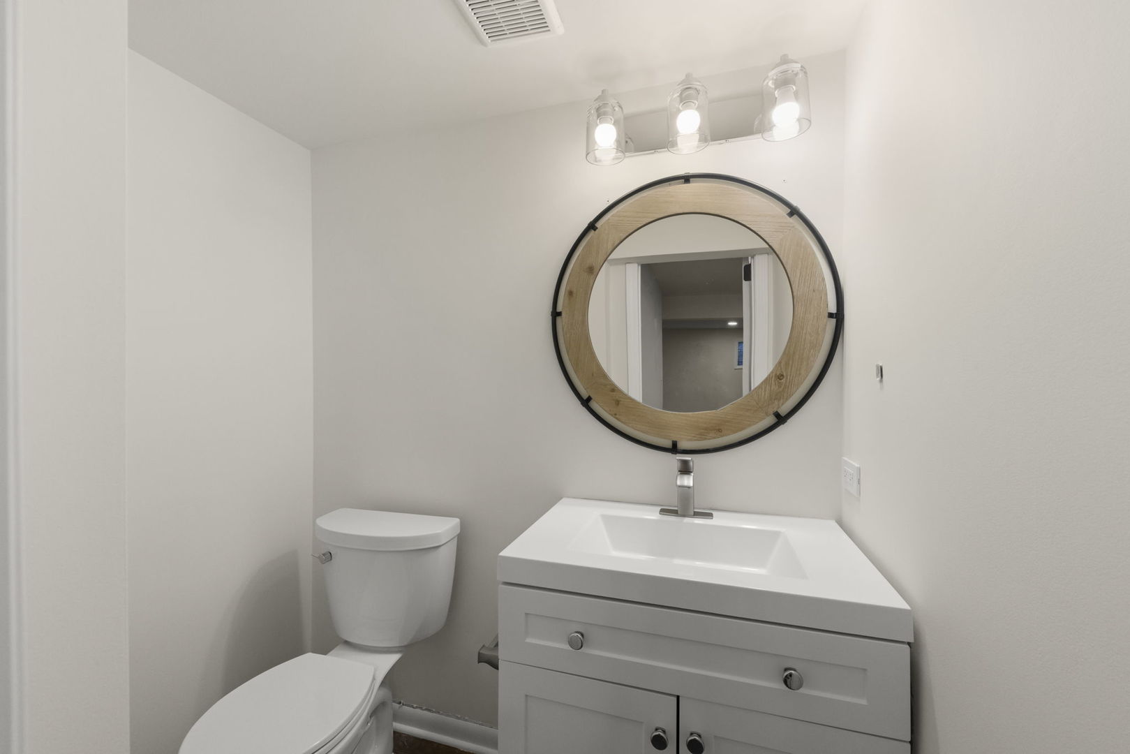 2823 Cooper Court Woodridge, IL 60517 - Photo 29 of 32 a bathroom with a sink a toilet and a mirror