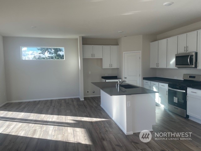 2822 Laurel Loop Milton, WA 98354 - Photo 3 of 6 a kitchen with granite countertop a stove a sink and a refrigerator