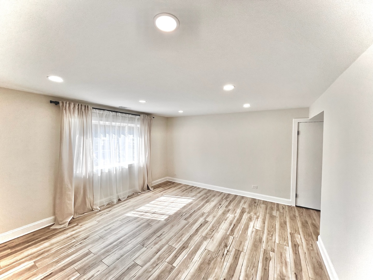 244 East Rimini Court Palatine, IL 60067 - Photo 2 of 8 an empty room with wooden floor and windows