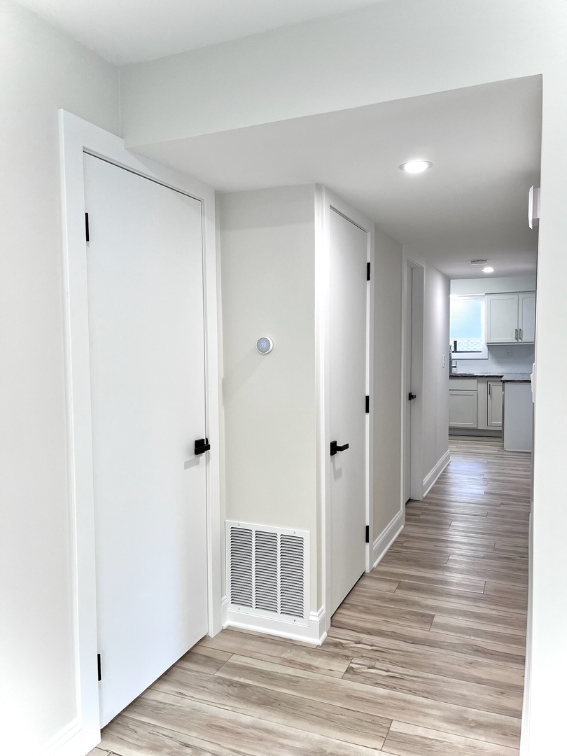 244 East Rimini Court Palatine, IL 60067 - Photo 3 of 8 a view of a hallway with wooden floor and a kitchen