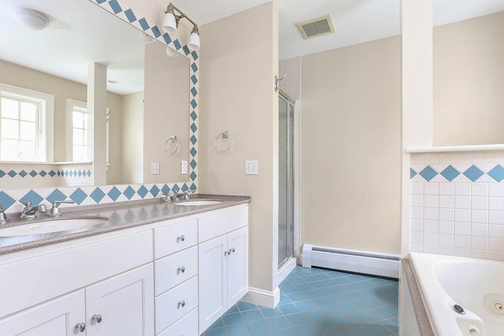 10 Woodside Road Topsfield, MA 01983 - Photo 17 of 30 a bathroom with a double vanity sink and a mirror
