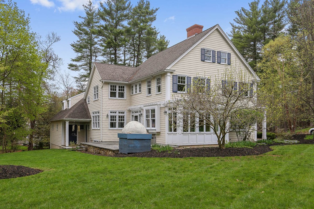 10 Woodside Road Topsfield, MA 01983 - Photo 23 of 30 a front view of a house with a garden and trees