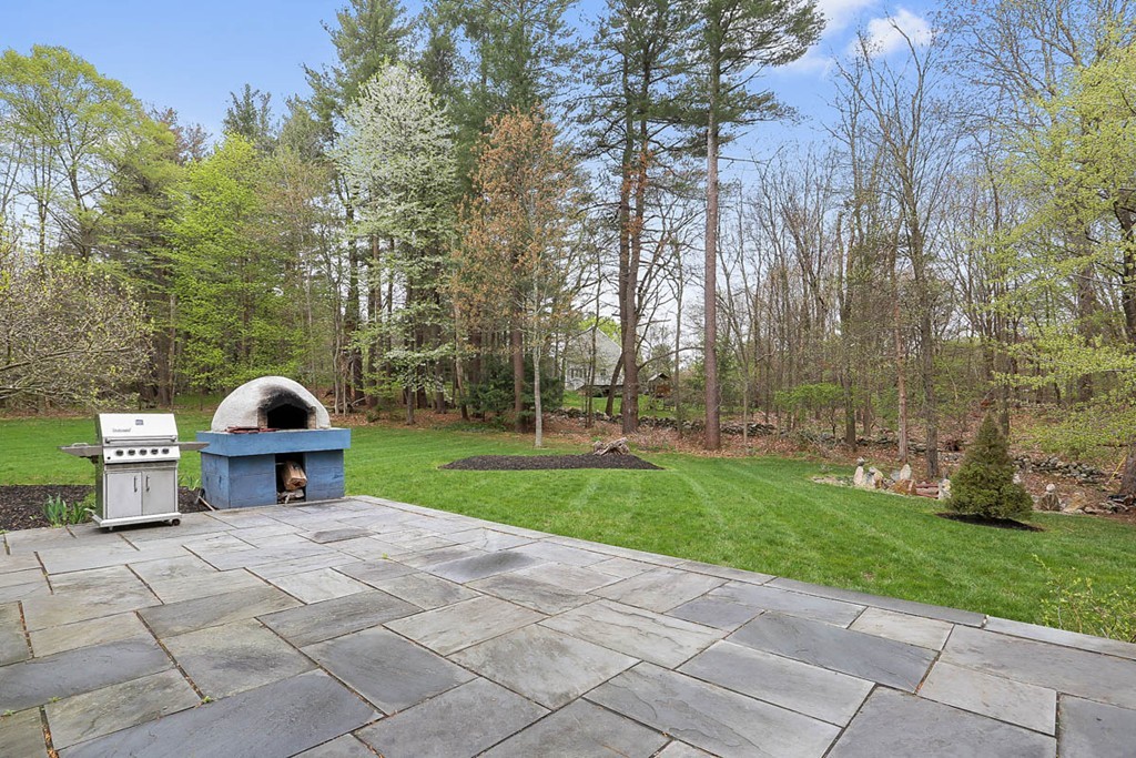 10 Woodside Road Topsfield, MA 01983 - Photo 27 of 30 a view of a yard with a bench and trees