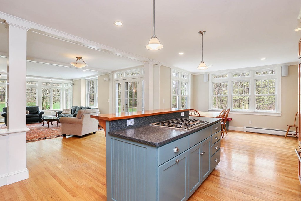 10 Woodside Road Topsfield, MA 01983 - Photo 4 of 30 a kitchen with stainless steel appliances granite countertop a stove a sink a counter space and living room view