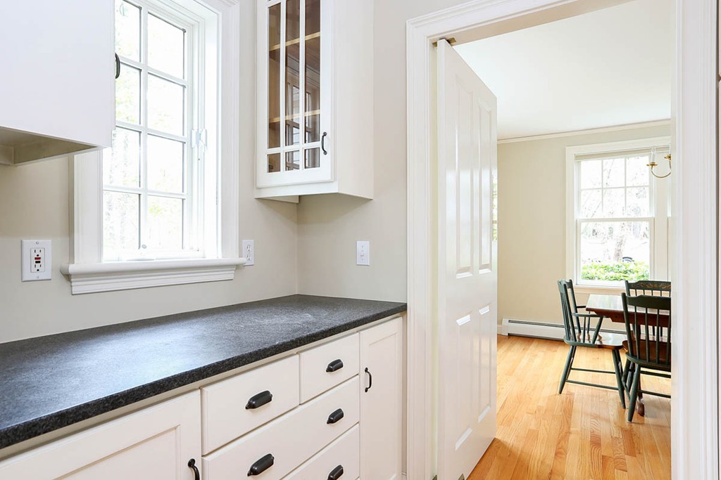 10 Woodside Road Topsfield, MA 01983 - Photo 7 of 30 a kitchen with granite countertop cabinets and chairs next to a window