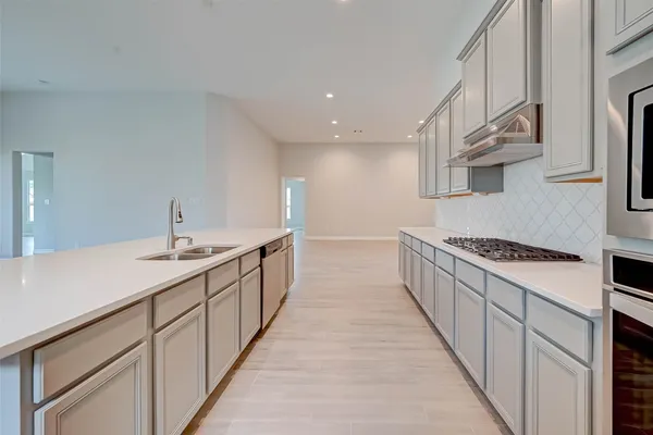 a kitchen with stainless steel appliances a sink and a stove