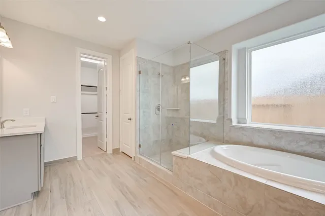 a bathroom with a tub shower and sink