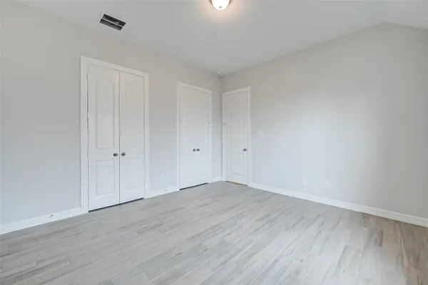 a view of an empty room and wooden floor