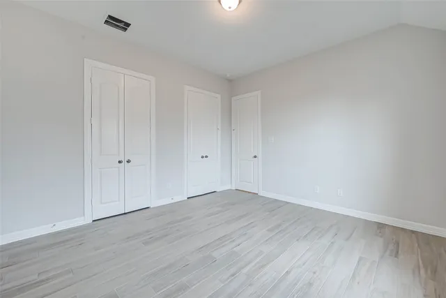 a view of an empty room and wooden floor