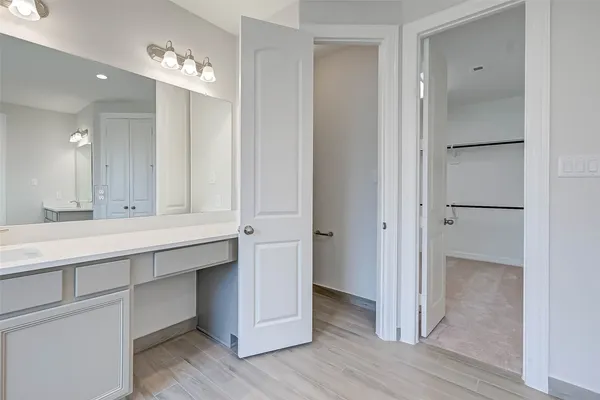 a bathroom with a double vanity sink and mirror