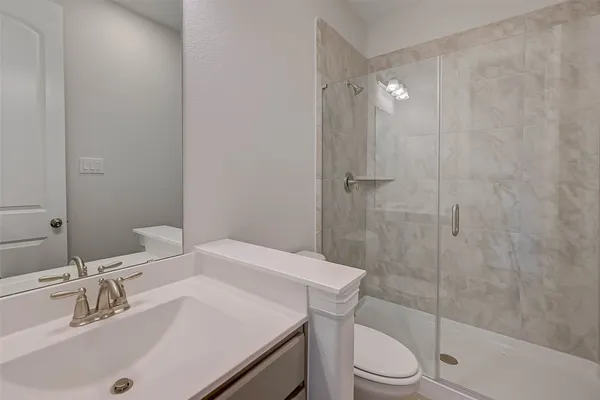 a bathroom with a sink toilet and shower